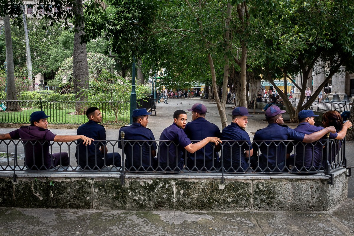 Police officers taking a rest in a park, Havana, Cuba.