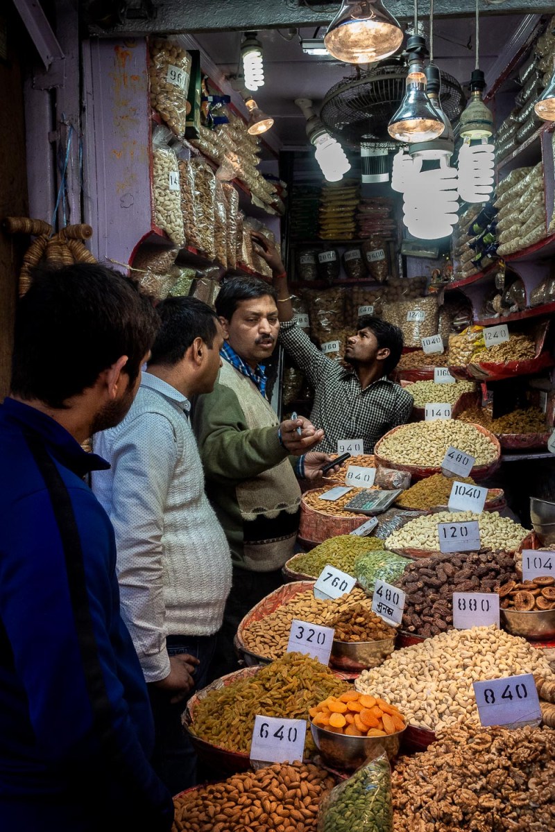 Men lining up to by nuts, Old Delhi, India.