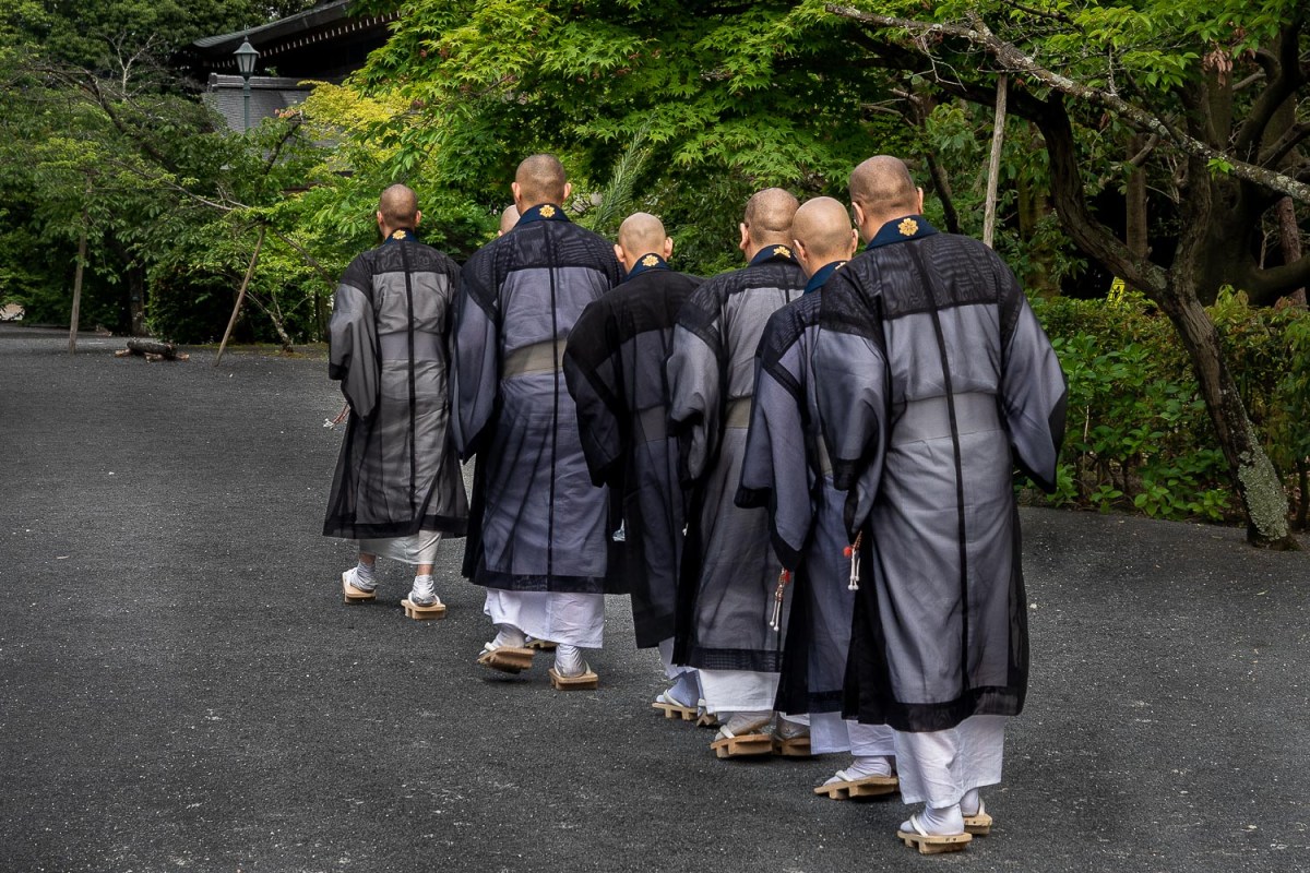 Monks at the Ninna-ji pagoda, Kyoto, Japan.