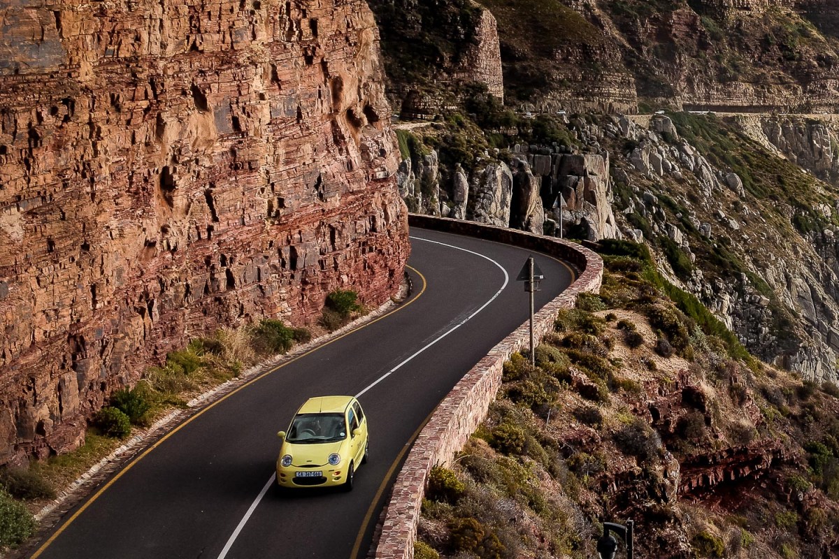 A car navigating the winding road, Chapman’s Peak Drive, South Africa.