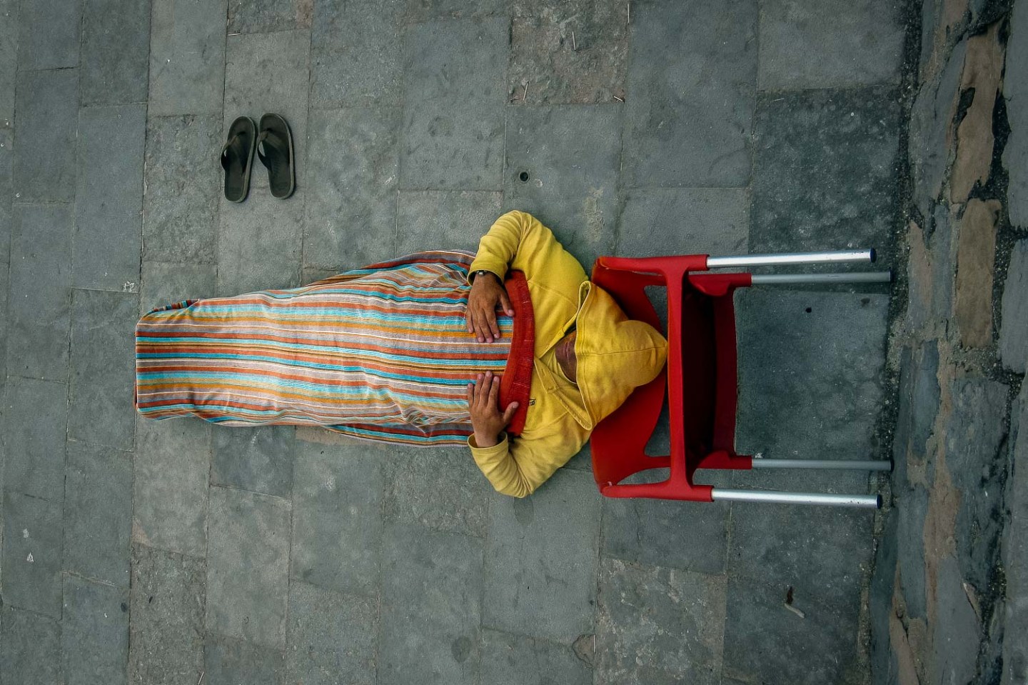 Man sun tanning with clothes, Estoril, Portugal.